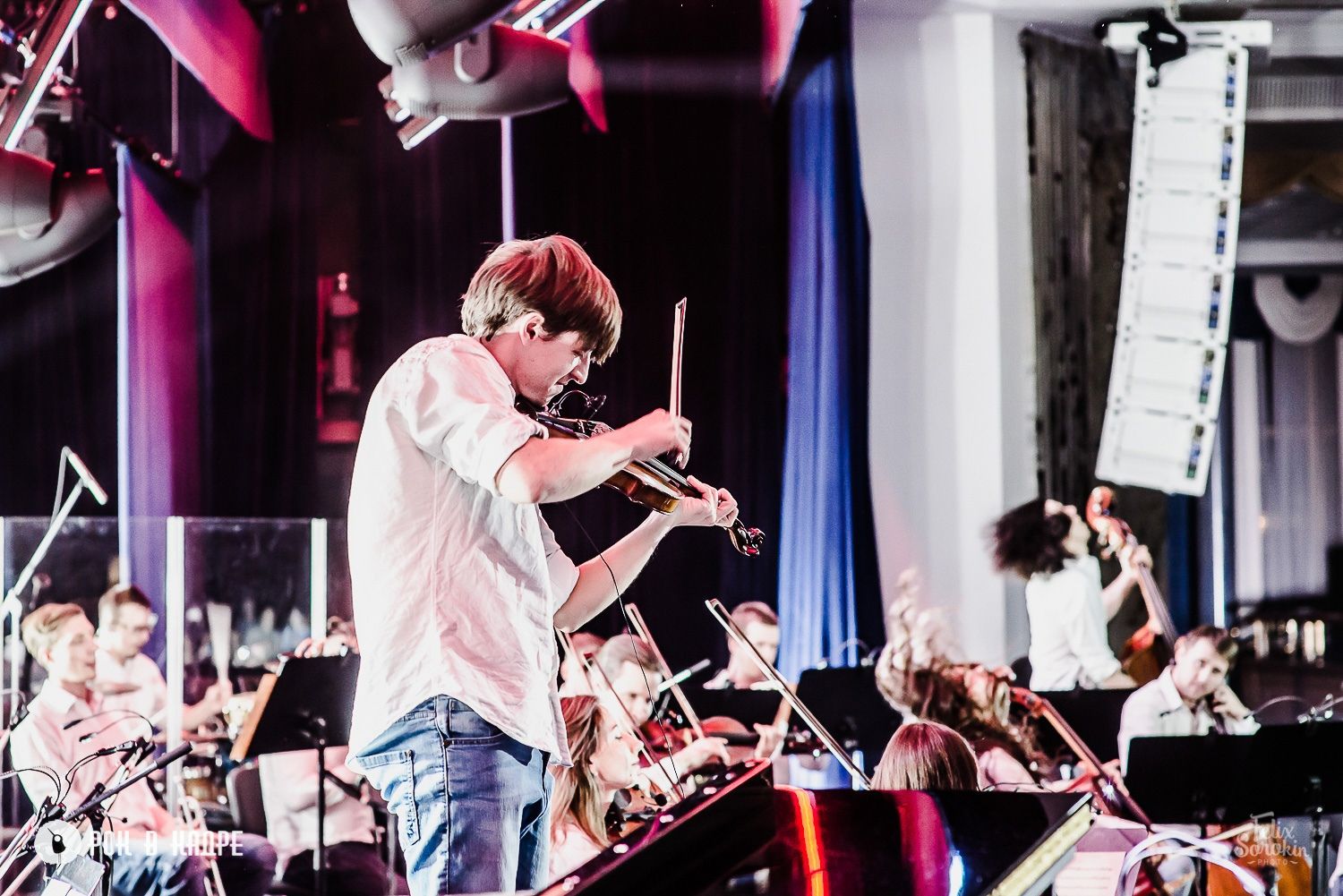 Sergey Akimov conducting on a colourful concert stage