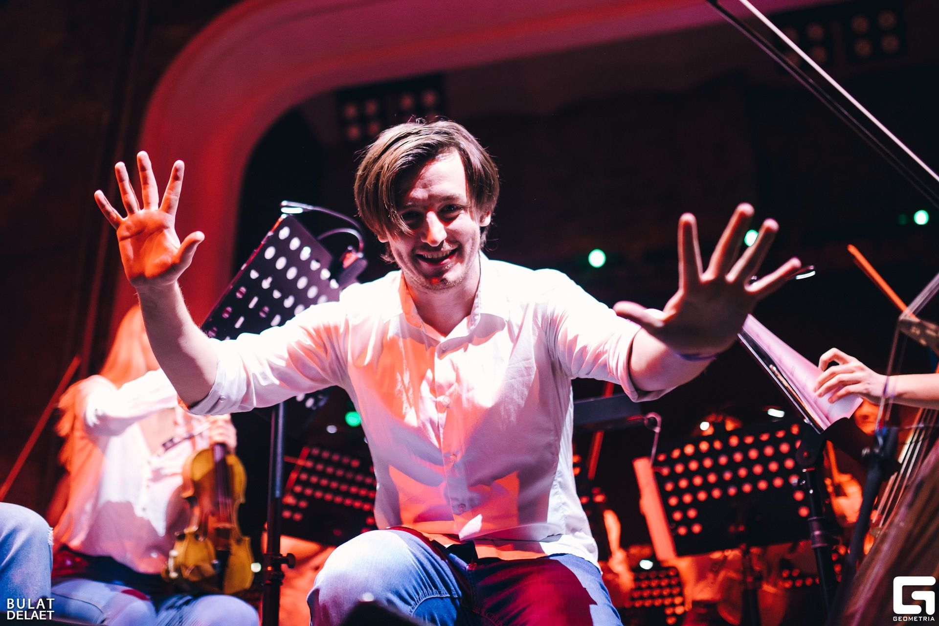 Sergey Akimov gesturing to the audience during a concert