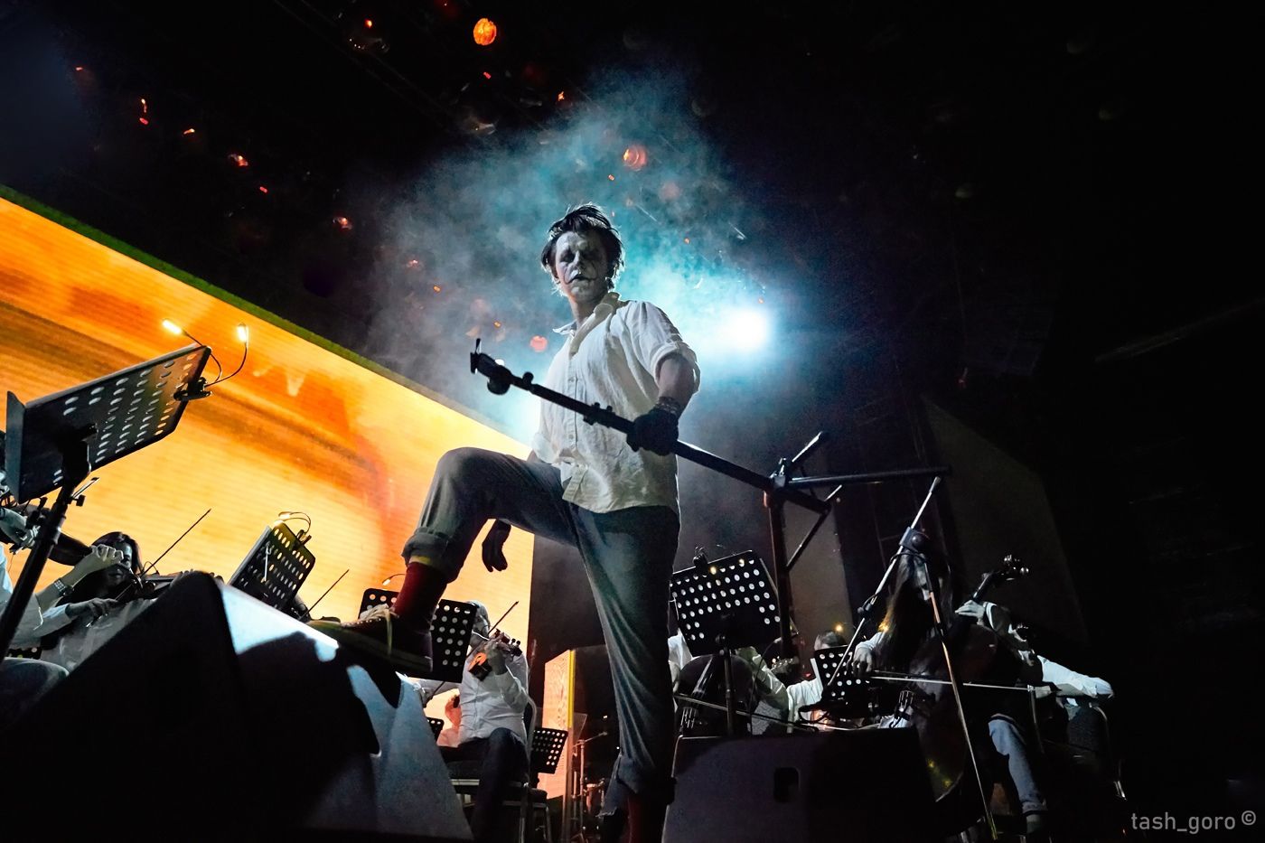 Sergey Akimov conducting under coloured stage lights