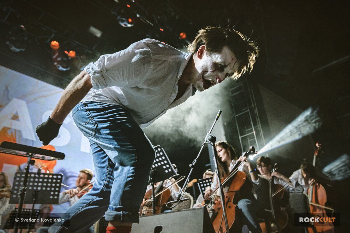 Sergey Akimov on a concert platform with vivid stage lighting
